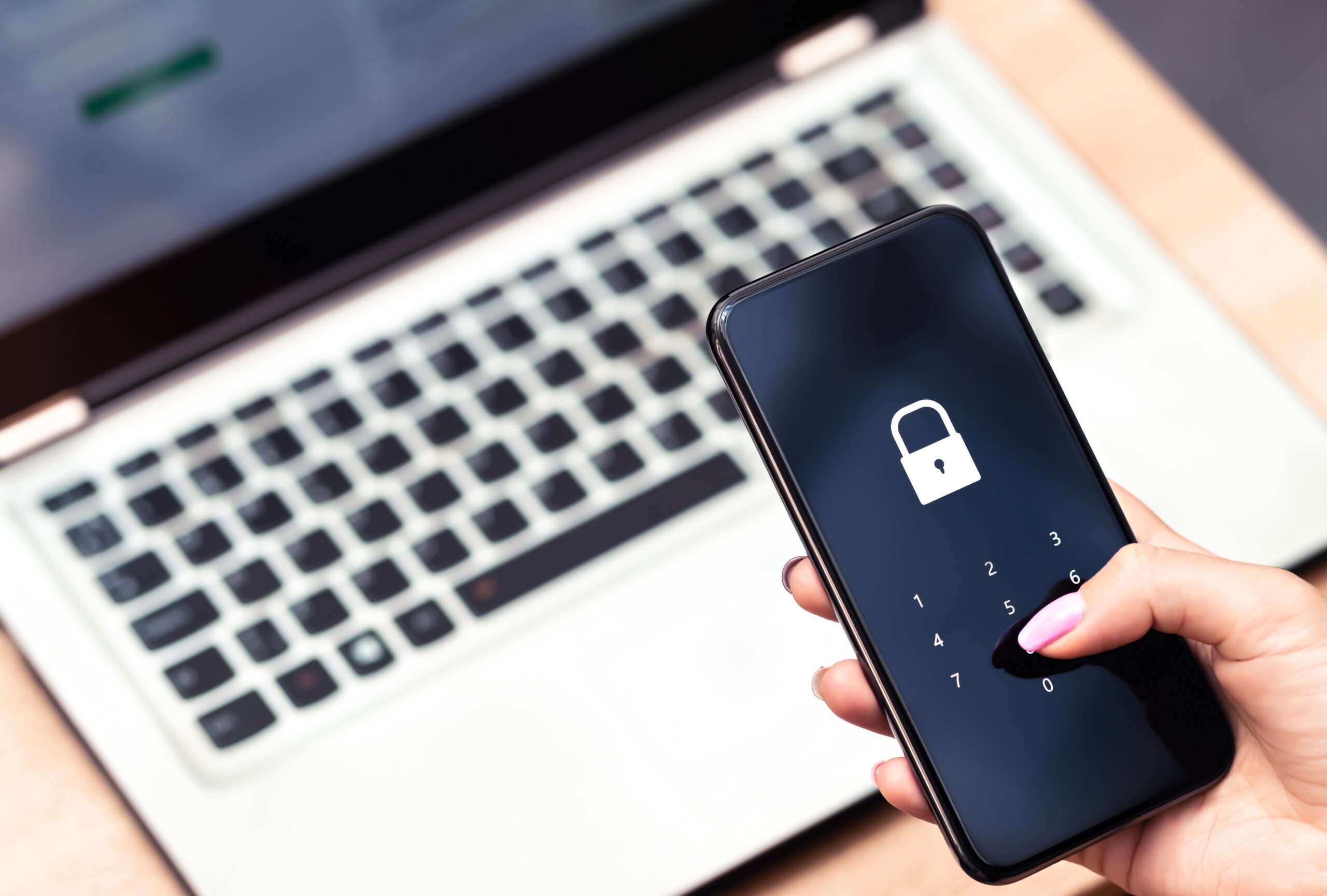 Phone password lock for mobile cyber security or login verification passcode in online bank app. Data privacy and protection from hacker, identity thief or cybersecurity threat. Laptop and smartphone.